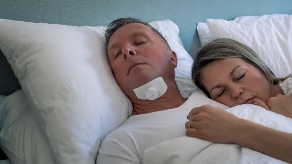 Man treating his obstructive sleep apnea with Genio