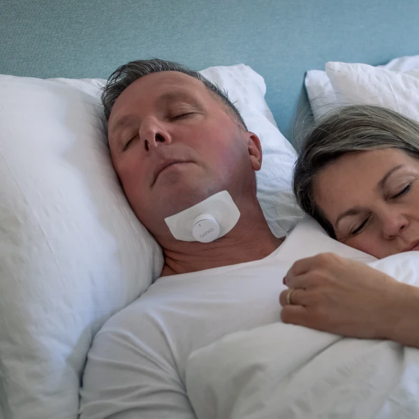 Man treating his obstructive sleep apnea with Genio